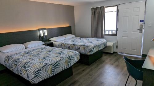 a hotel room with two beds and a window at Motel 6-Leominster, MA in Leominster