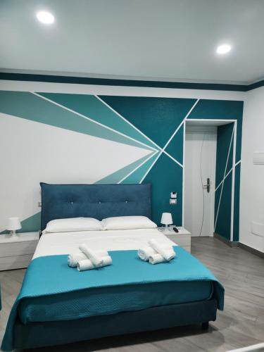 a bedroom with a blue bed with two towels on it at Gradini Partenopei in Naples
