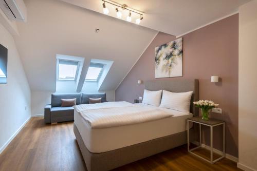 a bedroom with a bed and a couch at Hidden Art Boutique Residence by Dwellfort in Prague