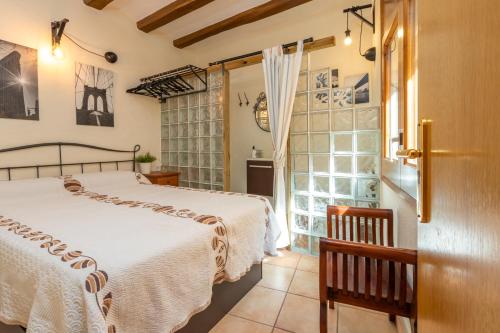 a bedroom with two beds and a sliding glass door at Duna in Palamós