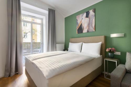 a bedroom with a large bed and a window at Hidden Art Boutique Residence by Dwellfort in Prague