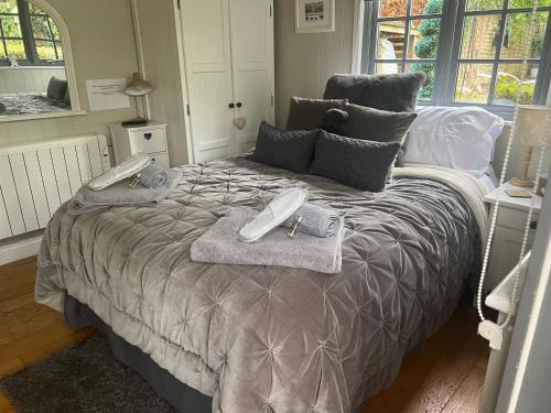 a bed with two phones on top of it at Truffle Lodge in Lindfield