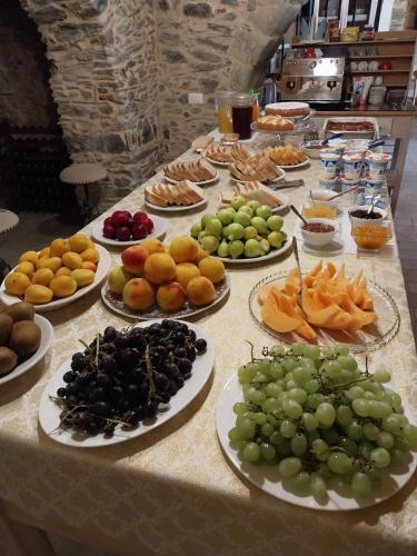 a table with many plates of fruit on it at La Casa della Filanda in Belmonte Calabro