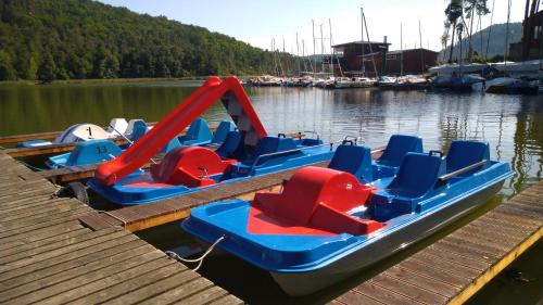 a boat with a slide and chairs on a dock at Pension Fami Retro Design in Staré Splavy