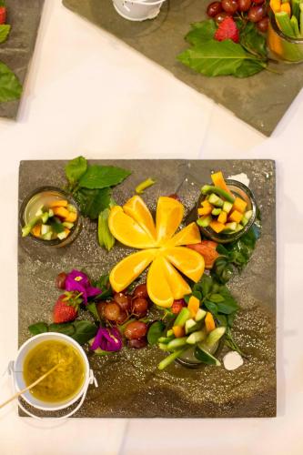 a plate of fruits and vegetables on a table at The Residences at Karen in Nairobi