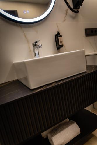 a bathroom sink with a mirror on a counter at HOTEL CORONA DE PADRÓN in Padrón