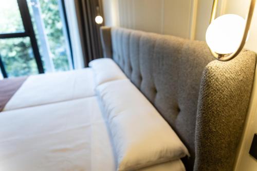 a couch with a lamp next to a window at HOTEL CORONA DE PADRÓN in Padrón