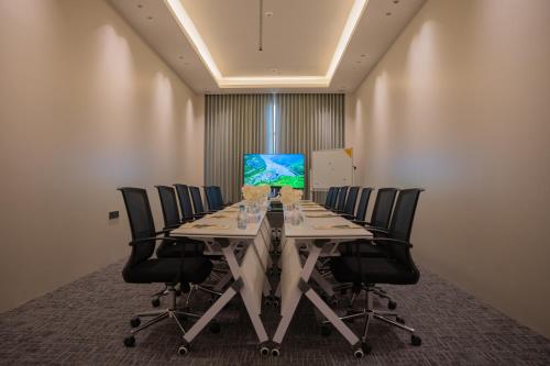 a conference room with a long table with chairs at Rosemond Al Hamra in Jeddah