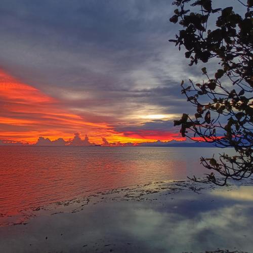 a sunset over a body of water at Zara's Casa Rental in Siquijor