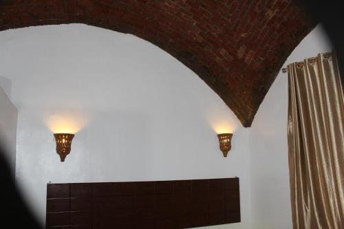 two lights on a wall next to a window at Nile View Guest House in Aswan