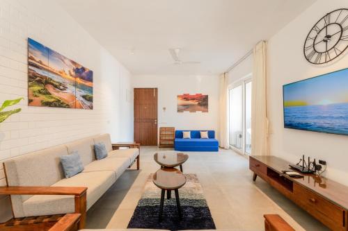 a living room with a couch and a table at HideAway 2BHK Villa Style Apartment - Stay To Unwind in Old Goa