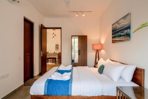 a bedroom with a bed and a table at HideAway 2BHK Villa Style Apartment - Stay To Unwind in Old Goa