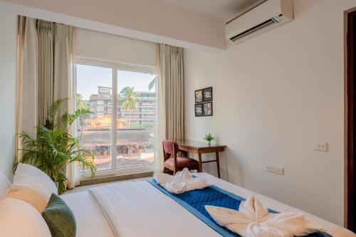a hotel room with a bed and a window at HideAway 2BHK Villa Style Apartment - Stay To Unwind in Old Goa