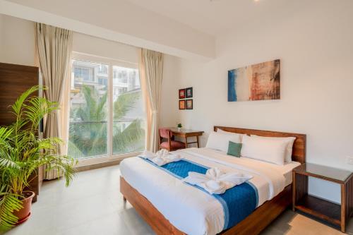 a bedroom with a bed and a large window at HideAway 2BHK Villa Style Apartment - Stay To Unwind in Old Goa