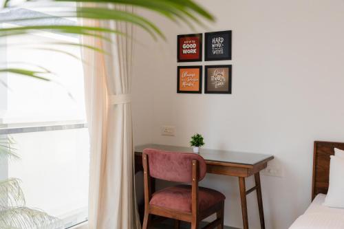 a bedroom with a desk and a chair and a window at HideAway 2BHK Villa Style Apartment - Stay To Unwind in Old Goa