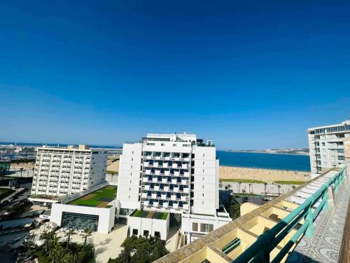 a view of a city with buildings and the ocean at Luxueux Appartement centre et plage & wifi ! in Tangier