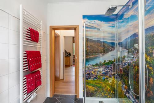 a bathroom with a shower with a painting on the wall at Ferienwohnungen Engelmannstift in Bacharach