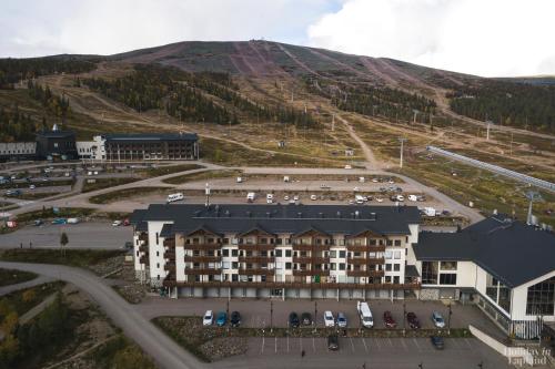 an aerial view of a building with a parking lot at Holiday in Lapland - Ylläs Gondola apartment, huoneisto 6207 in Ylläsjärvi