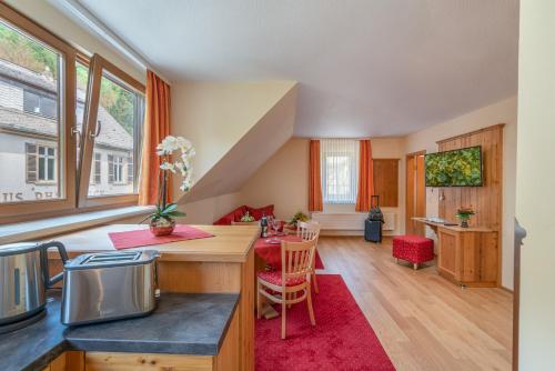 a kitchen with a counter and a table in a room at Ferienwohnungen Engelmannstift in Bacharach