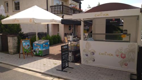 a food stand with an umbrella on a street at Rezidence Fami Deluxe Design in Staré Splavy