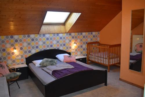 a bedroom with a bed with a stuffed animal on it at Gite 1 de Renuamont in Sainte-Ode