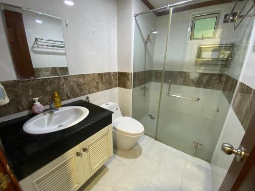 a bathroom with a shower and a sink and a toilet at Spacious Apartment with 3-bedroom in District 7 in Ho Chi Minh City