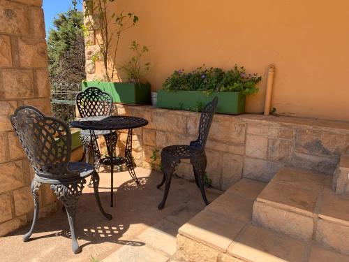two chairs and a table on a patio at Auldstone House in Dullstroom