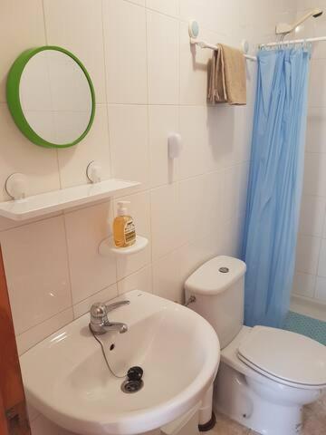 a bathroom with a sink and a toilet and a mirror at Villa Limon Playa Flamenca in Alicante