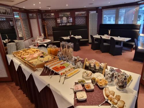 a table with many different types of food on it at Hotel Willinger Mitte in Willingen