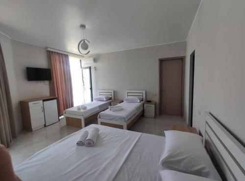 a hospital room with two beds and a tv at The best guest house-GAIOZ in Gonio