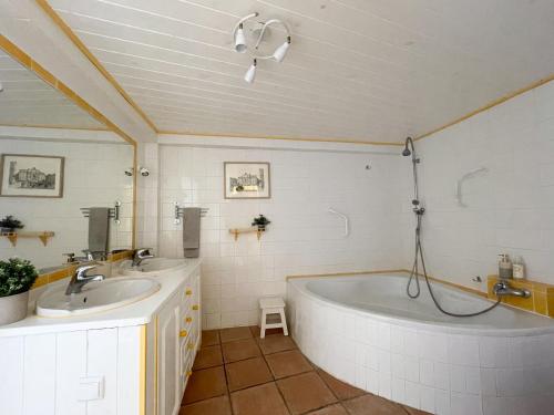a bathroom with two sinks and a bath tub at Charming Countryside Home with Fireplace & Patio in Alcoutim