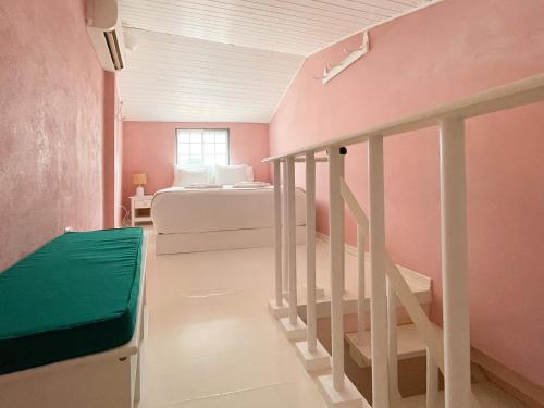 a bedroom with a bed and a stairway with a bed and a stair case at Charming Countryside Home with Fireplace & Patio in Alcoutim