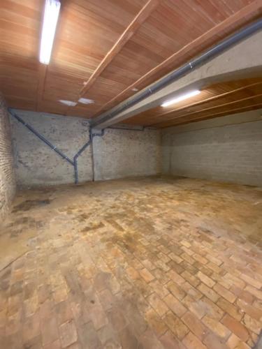 an empty garage with a wooden floor and a ceiling at Les Quais de la Vesdre in Verviers