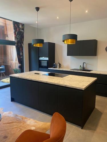 a kitchen with a large island with a counter top at Les Quais de la Vesdre in Verviers