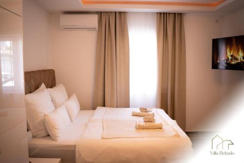 a hotel room with a bed with towels on it at Belrado Apartments in Belgrade