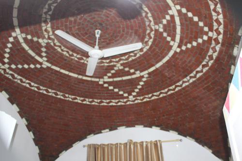 a large clock on a brick wall at Nile View Guest House in Aswan