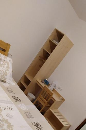 a room with a loft bed and wooden shelves at Chartreuse in Saint-Franc