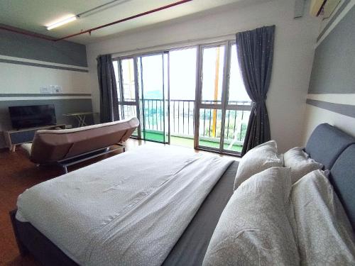 a hospital room with a bed and a large window at A's House i-City 1-4pax Studio Netflix Wifi in Shah Alam