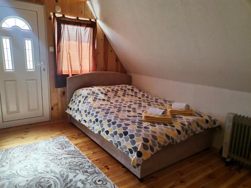 Village Cottage في زبلجك: غرفة نوم صغيرة بها سرير ونافذة