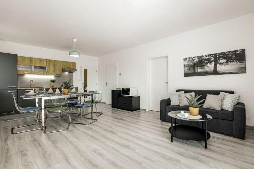 a living room with a couch and a table at KORZO Lipno in Lipno nad Vltavou