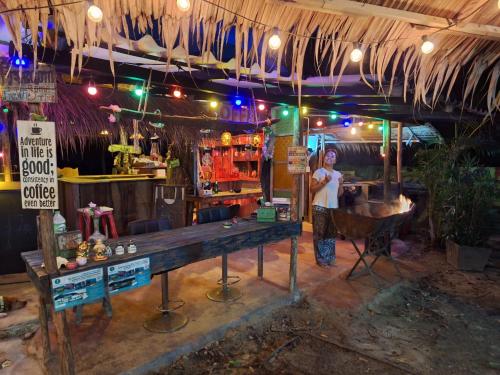 a woman standing in front of a bar at Freedom home in Ko Chang