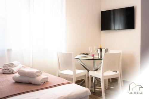 a room with a table and a bed and a table and chairs at Belrado Apartments in Belgrade