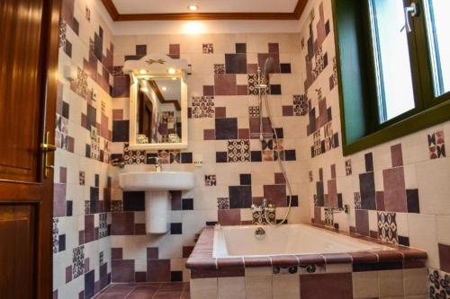 y baño con bañera, lavabo y espejo. en Casa Comana Boutique Hotel, en Bucarest