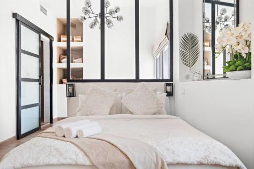 a bedroom with a bed with two towels on it at Chic Studio with a Bath Tub, Pool & Gym near Golf Club in Dubai