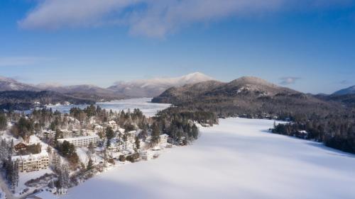 an aerial view of a snow covered lake and mountains at Lake Placid Inn Boutique Hotel in Lake Placid