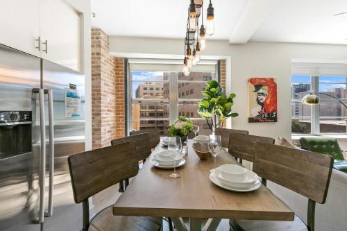 a dining room with a wooden table and chairs at Chic 4Bed Oasis Steps from French Quarter Magic! in New Orleans