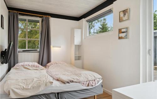 a small bedroom with a bed and a window at Gorgeous Home In Hadsund With Wifi in Hadsund