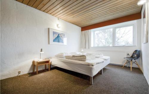 - une chambre avec un lit, une fenêtre et une chaise dans l'établissement Stunning Home In Knebel With House Sea View, à Knebel