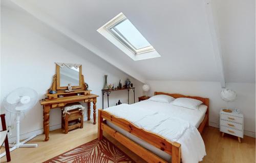 a bedroom with a bed and a mirror and a desk at Awesome Home In Dol-de-bretagne With 2 Bedrooms in Dol-de-Bretagne