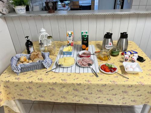 a table with food on it with a table cloth at Sjökaptensgården Bed & Breakfast in Åsljunga